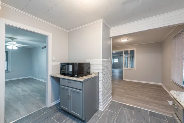 a kitchen with granite countertop a sink and stainless steel appliances