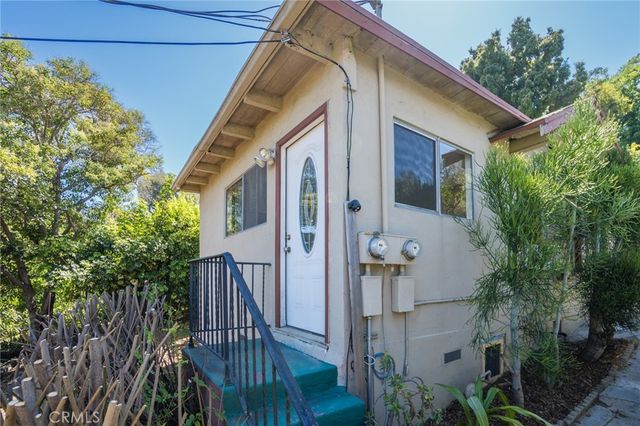 a view of room with hardwood floor and hallway