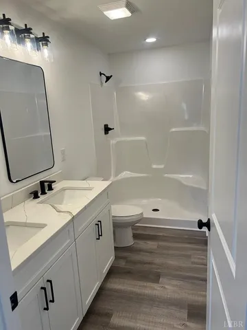 a white toilet sitting next to a bath tub