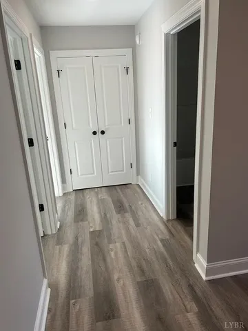 a view of a house with a large window and wooden fence