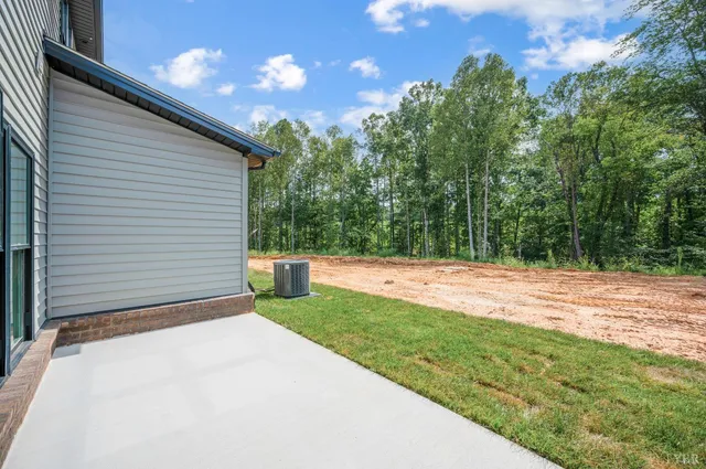 an aerial view of a house with a yard and lake view