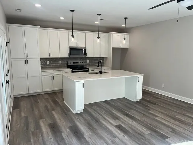 a kitchen with stainless steel appliances a sink and a refrigerator