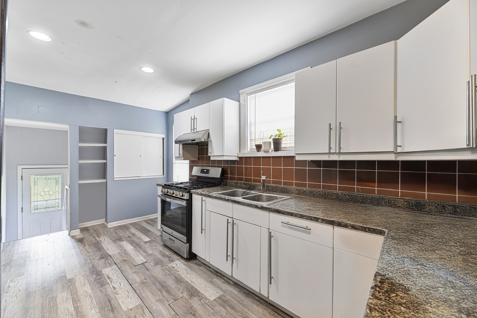 1S217 Valley Road Lombard, IL 60148 - Photo 6 of 23 a kitchen with stainless steel appliances granite countertop a lot of cabinets and wooden floor