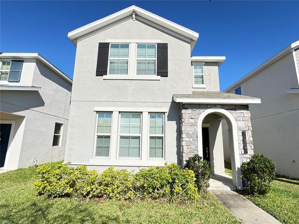 15127 Book Club Road Winter Garden, FL 34787 - Photo 1 of 1 a front view of a house with a garden