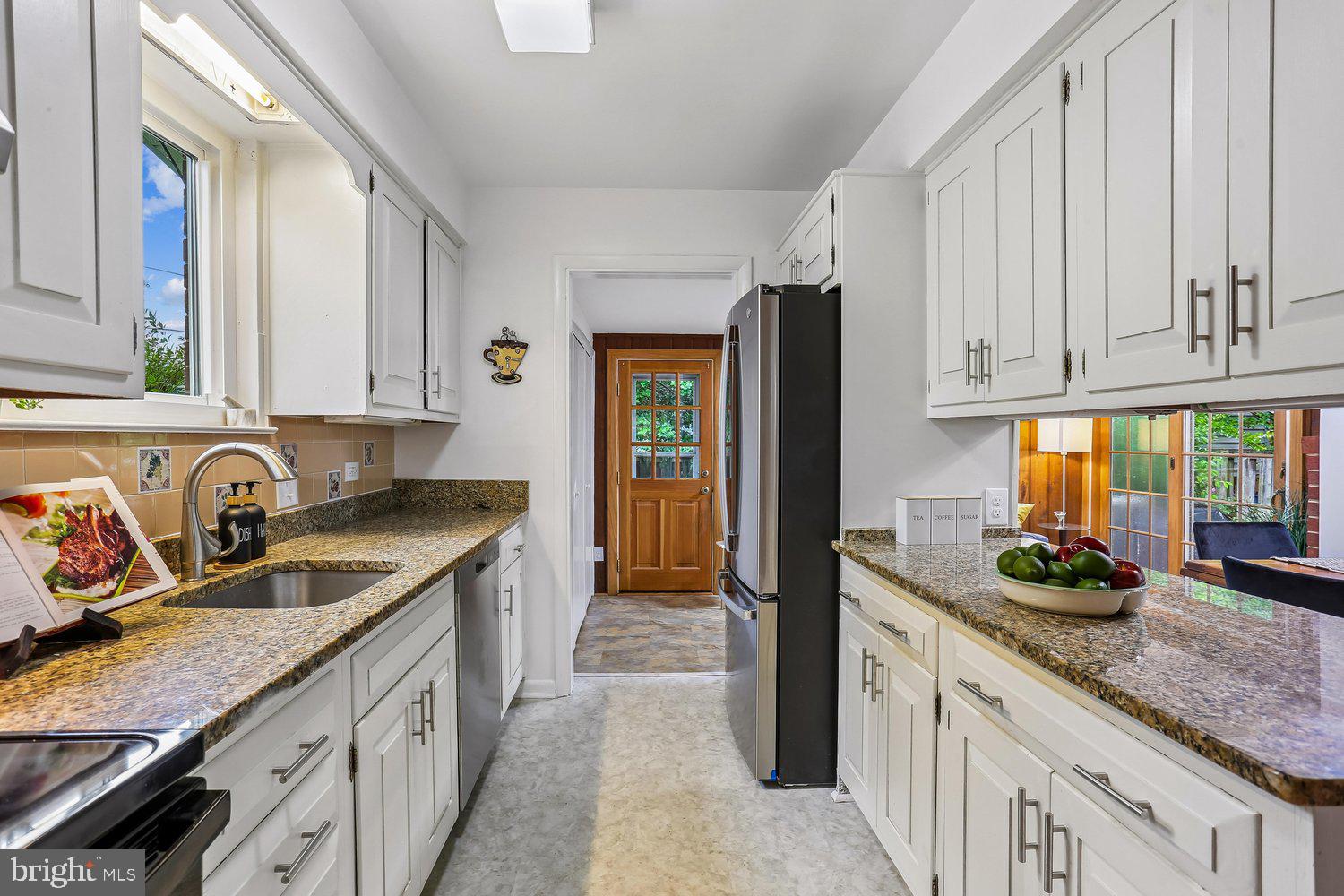 907 Hoyt Street Silver Spring, MD 20902 - Photo 23 of 69 a kitchen with granite countertop a sink stainless steel appliances and cabinets