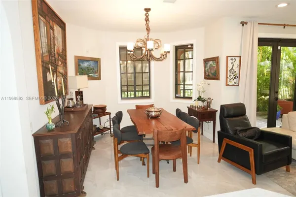 a living room with furniture a chandelier and a large window