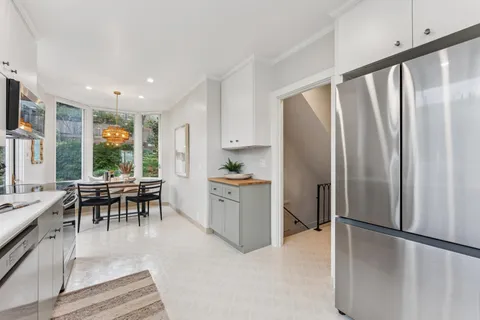 a view of an entryway with wooden floor and a livingroom