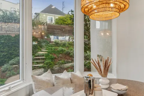 a spacious bedroom with a large bed and a chandelier