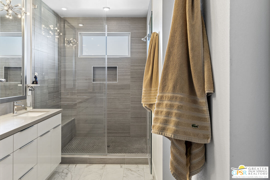 467 Huddle Spgs Way Palm Springs, CA 92264 - Photo 26 of 48 a bathroom with a shower and a sink