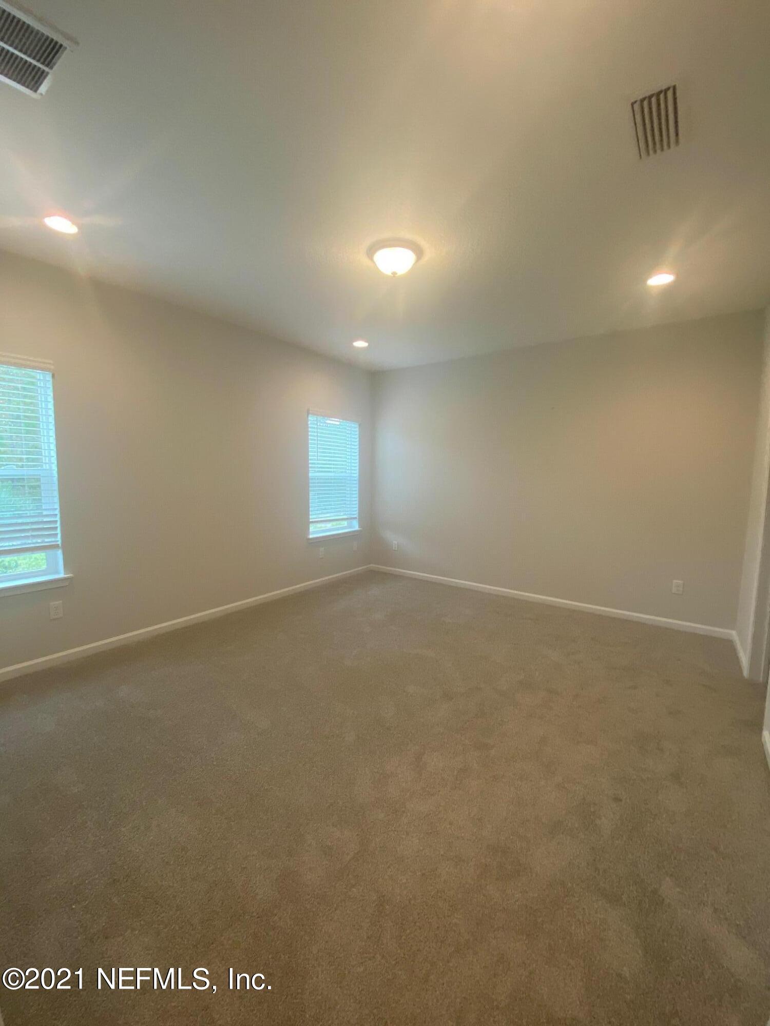 679 Windermere Way St. Augustine, FL 32095 - Photo 11 of 15 an empty room with a empty space and windows