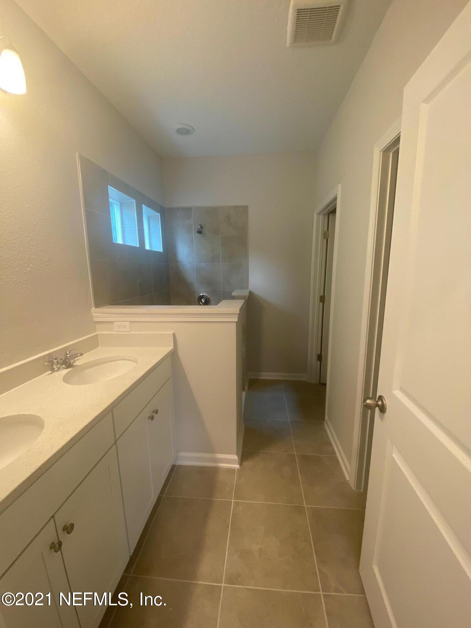 679 Windermere Way St. Augustine, FL 32095 - Photo 12 of 15 a bathroom with a sink a toilet and a shower