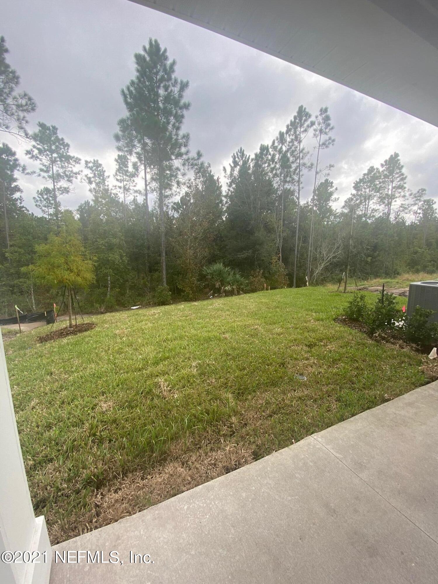 679 Windermere Way St. Augustine, FL 32095 - Photo 14 of 15 a view of a field with an trees in the background