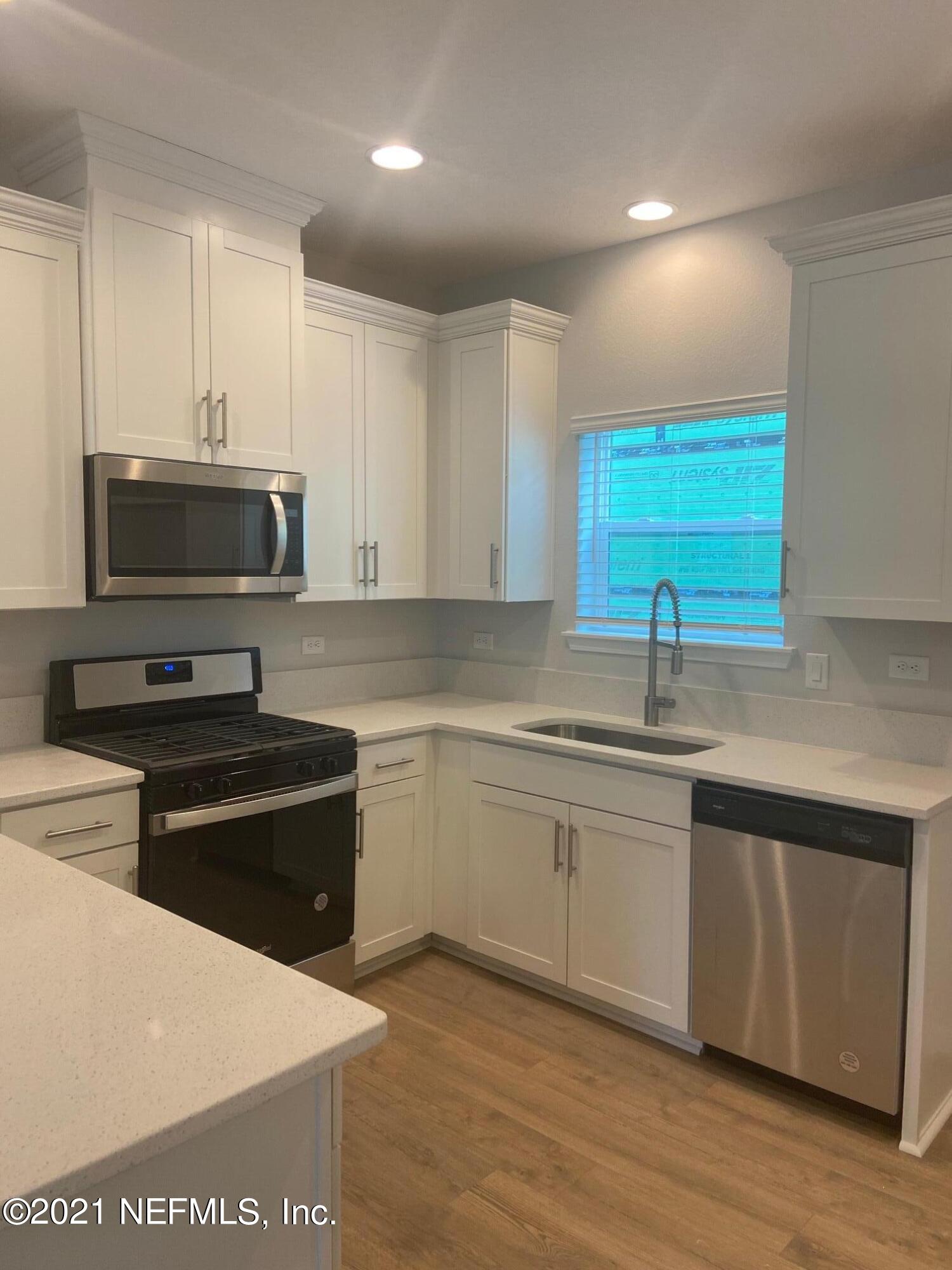 679 Windermere Way St. Augustine, FL 32095 - Photo 5 of 15 a kitchen with a sink and a stove top oven