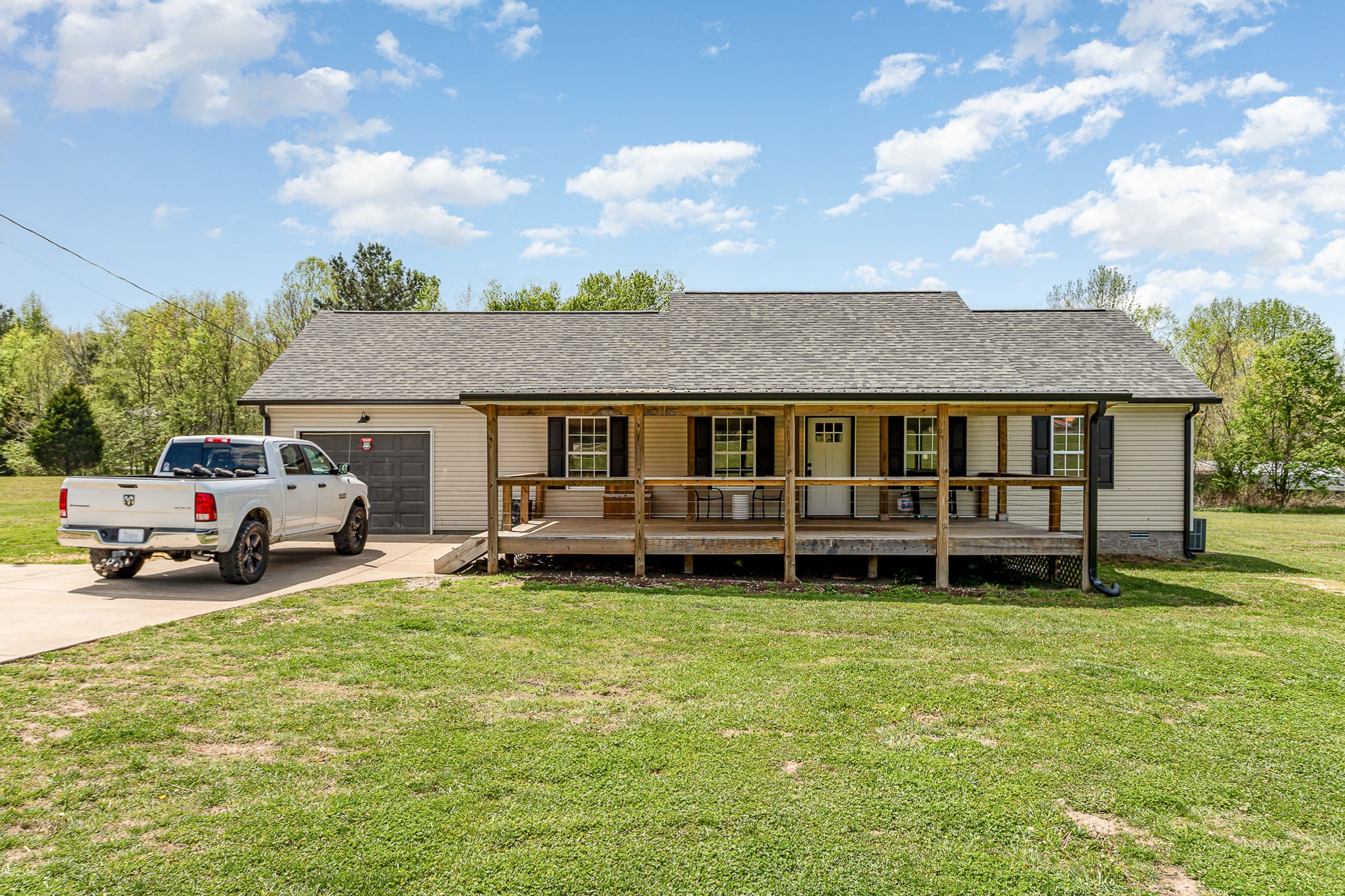 a view of a house with a yard and sitting area