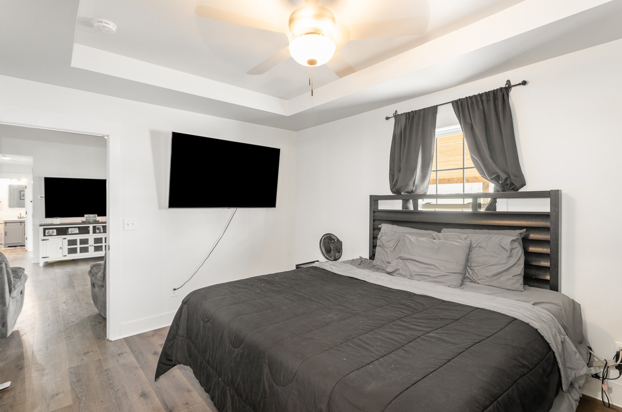 7953 Spot Light Road Lyles, TN 37098 - Photo 11 of 19 a bedroom with a bed and a flat screen tv