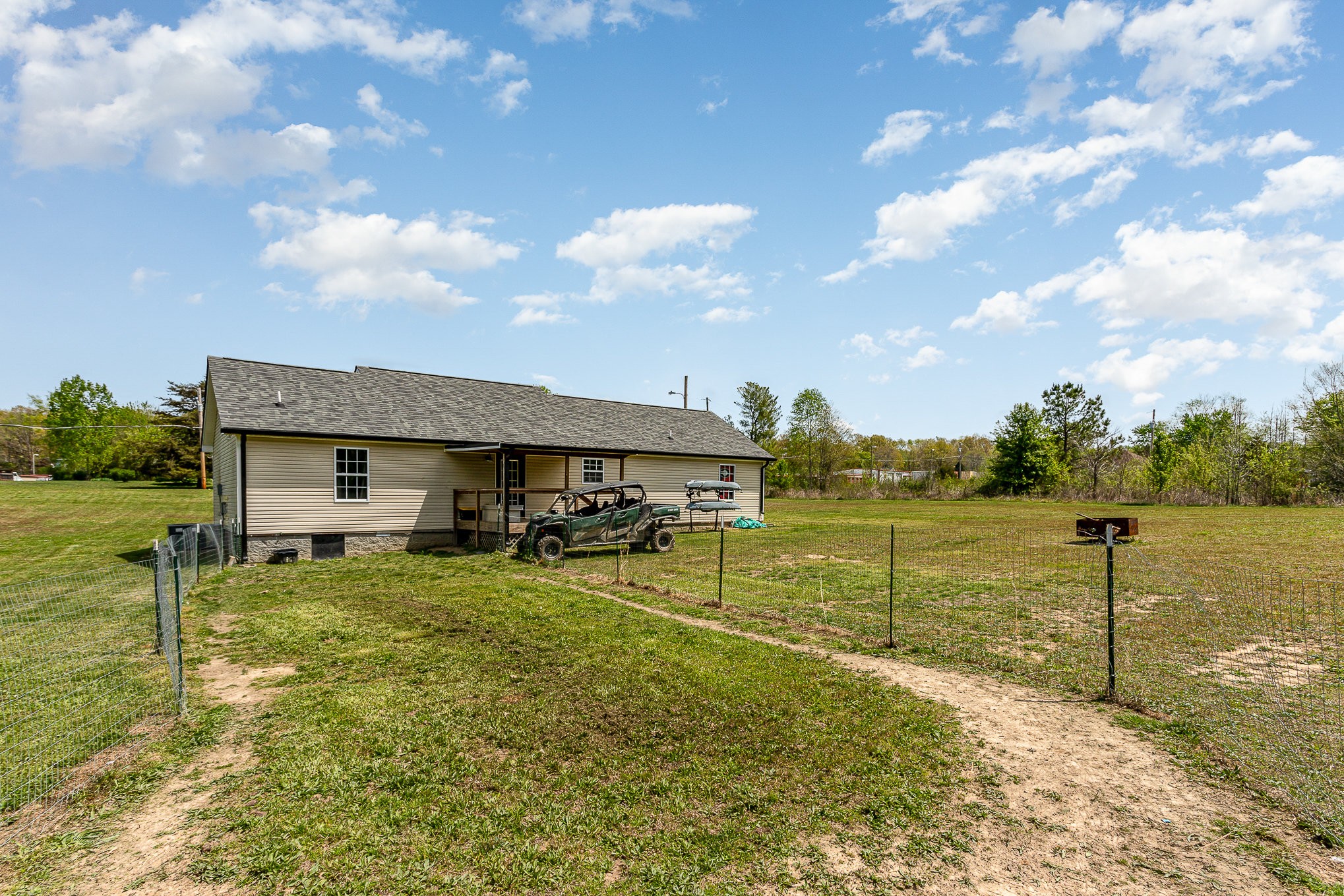 7953 Spot Light Road Lyles, TN 37098 - Photo 15 of 19 a view of a lake with table and chairs under an umbrella