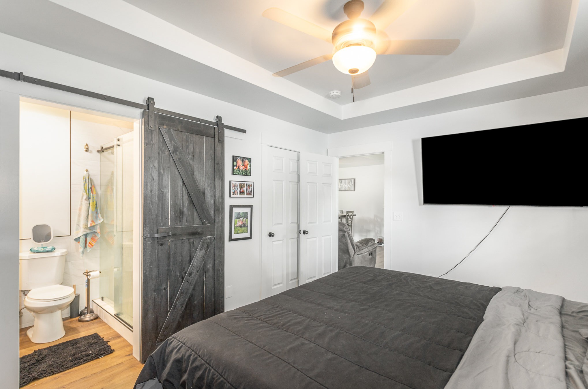 7953 Spot Light Road Lyles, TN 37098 - Photo 10 of 19 a bedroom with a bed and a flat screen tv
