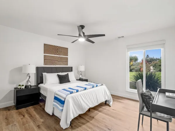 a bedroom with a bed and a large window