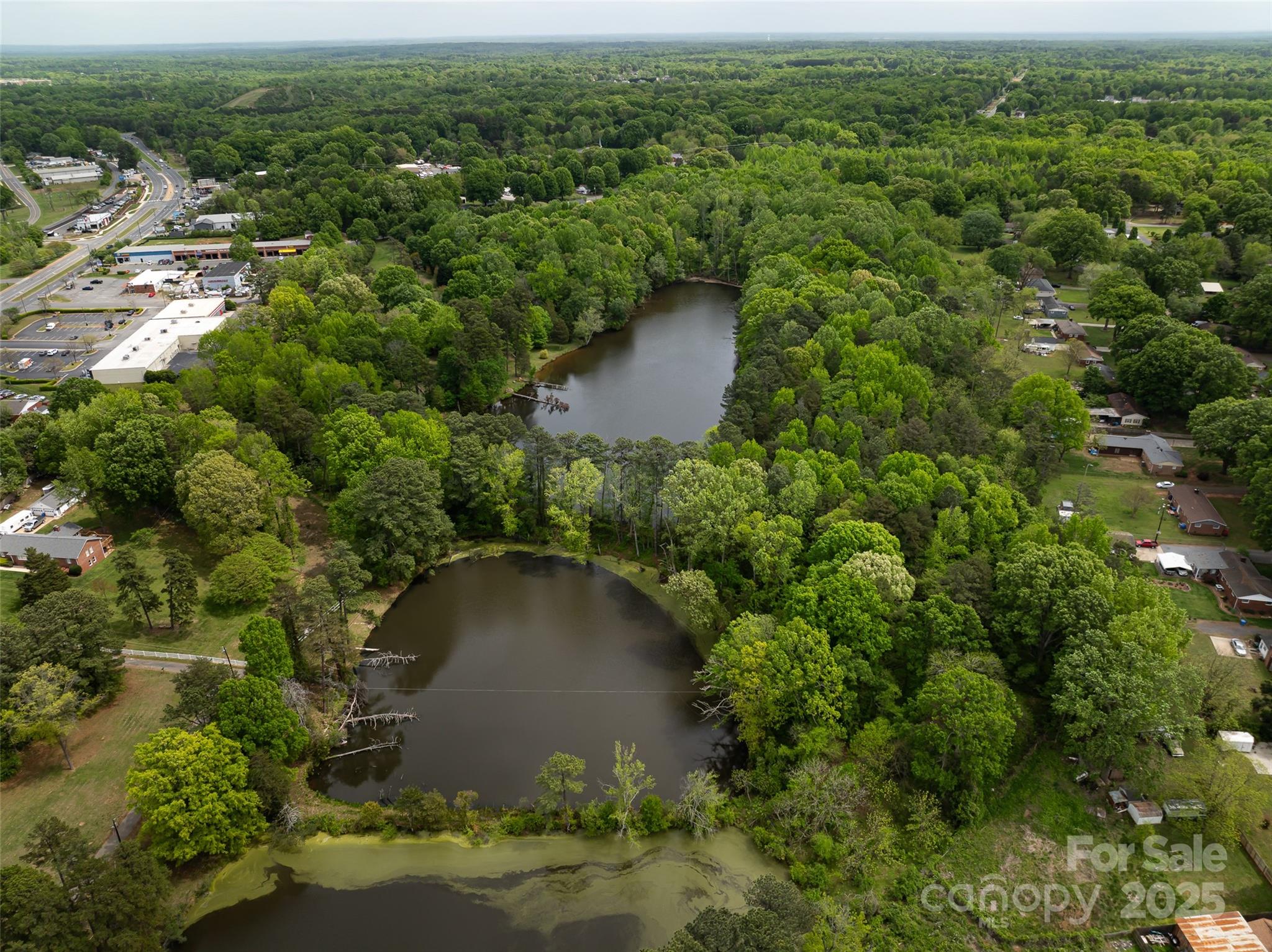 9836 Albemarle Road Charlotte, NC 28227 - Photo 1 of 13 an aerial view of a house with a yard and lake view