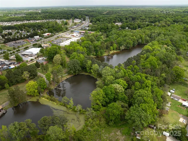 an aerial view of residential houses with outdoor space and river