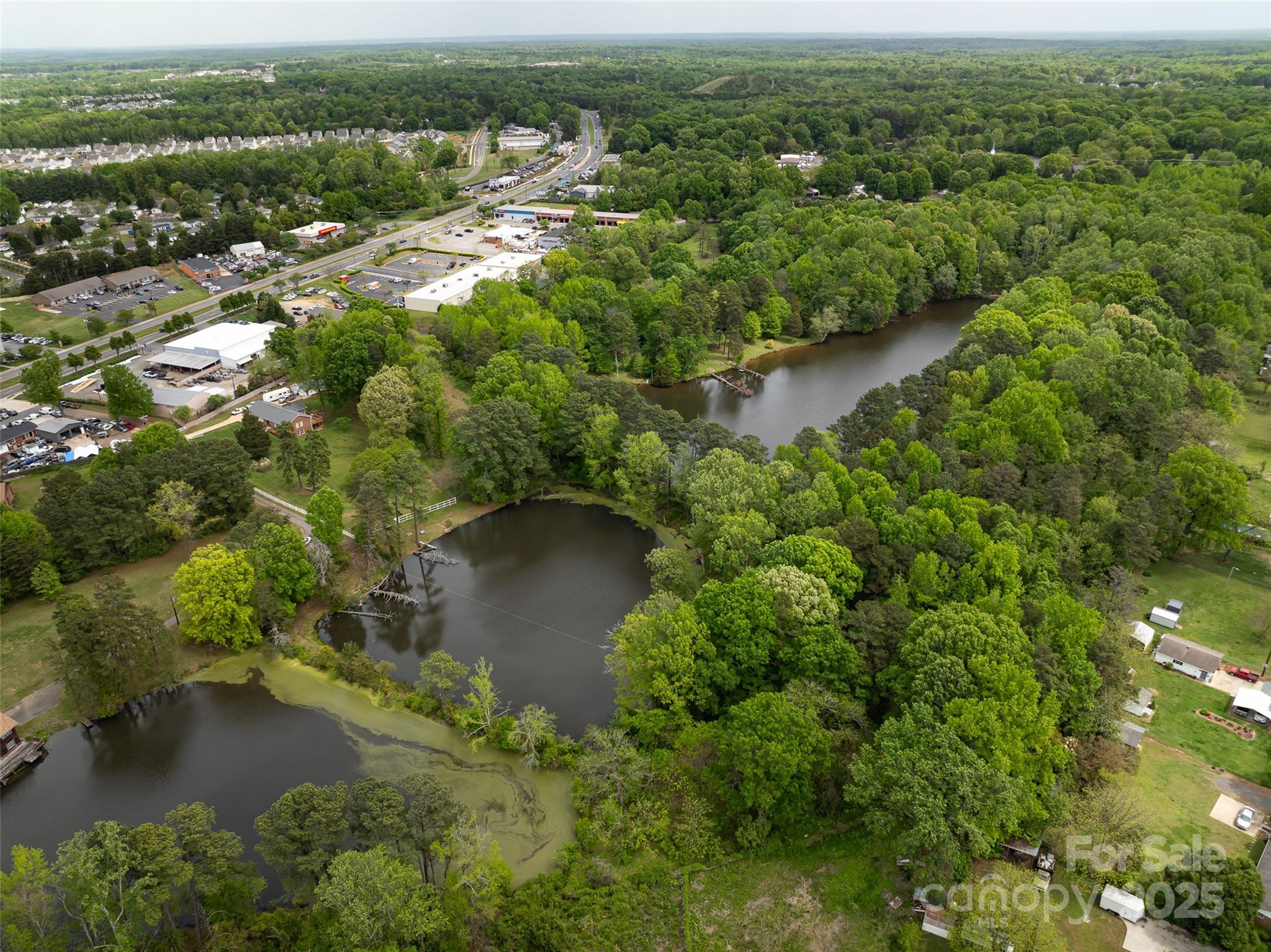 9836 Albemarle Road Charlotte, NC 28227 - Photo 2 of 13 an aerial view of residential houses with outdoor space and river