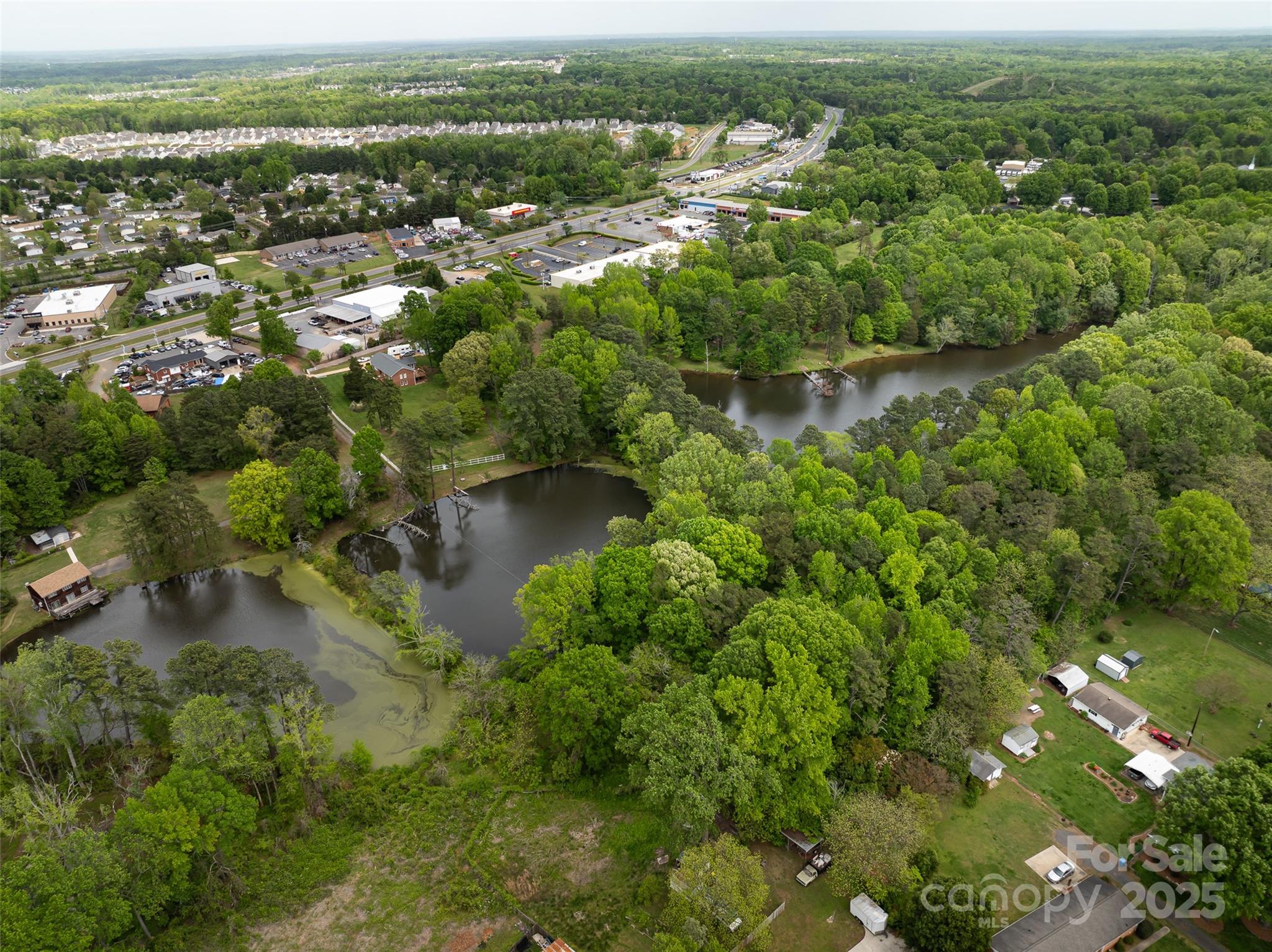 9836 Albemarle Road Charlotte, NC 28227 - Photo 3 of 13 an aerial view of residential houses with outdoor space and trees