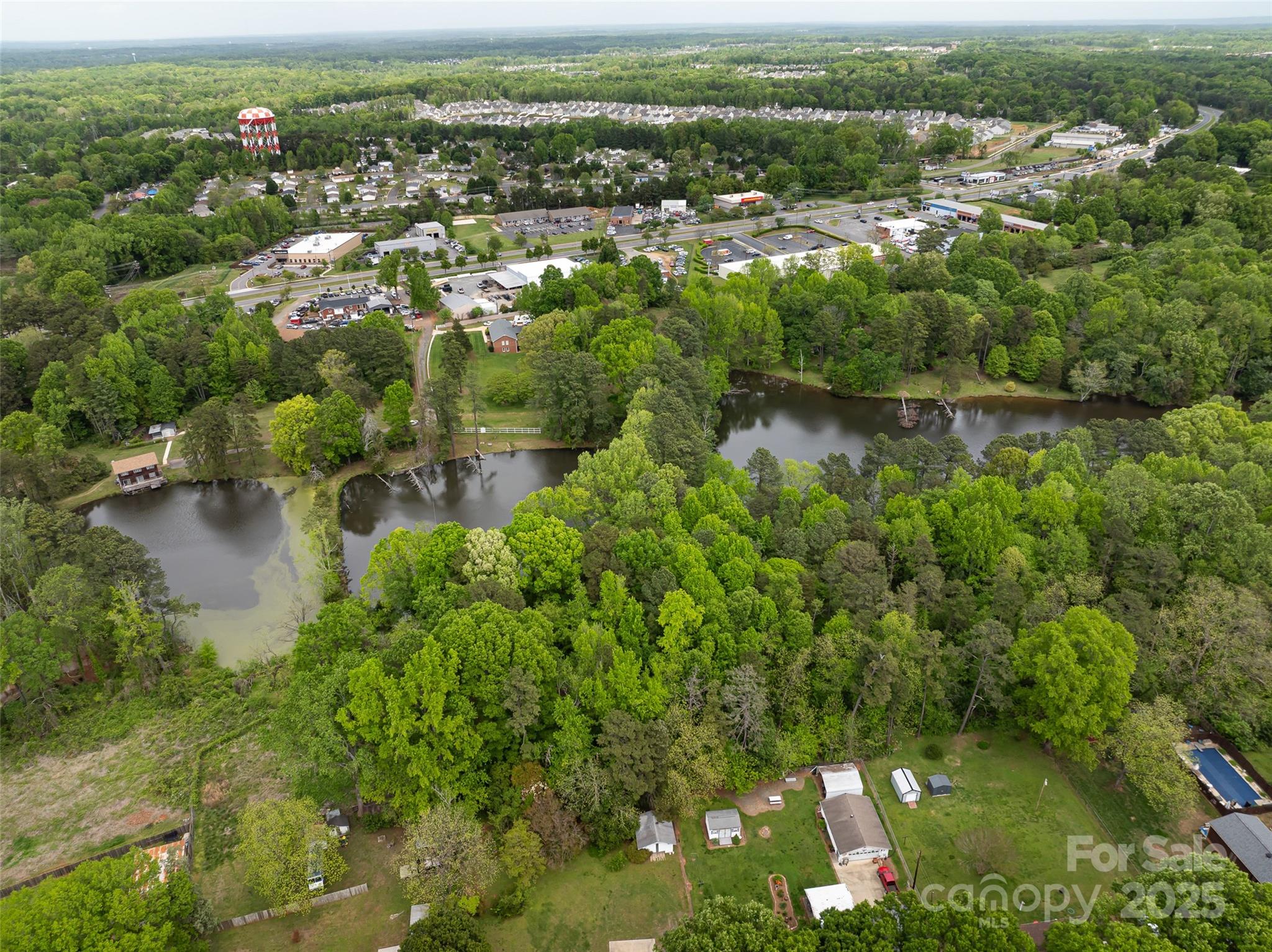 9836 Albemarle Road Charlotte, NC 28227 - Photo 4 of 13 an aerial view of residential houses with outdoor space and trees
