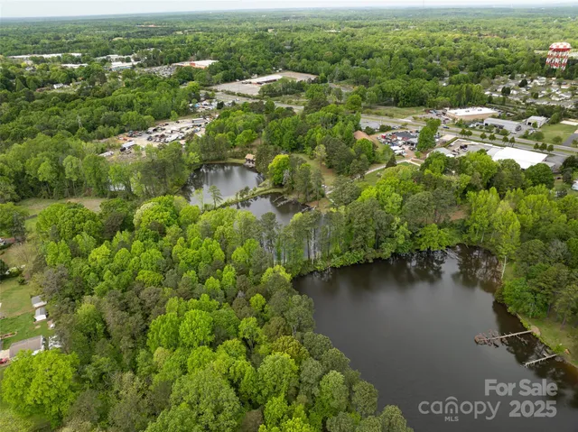 an aerial view of residential house with outdoor space and lake view