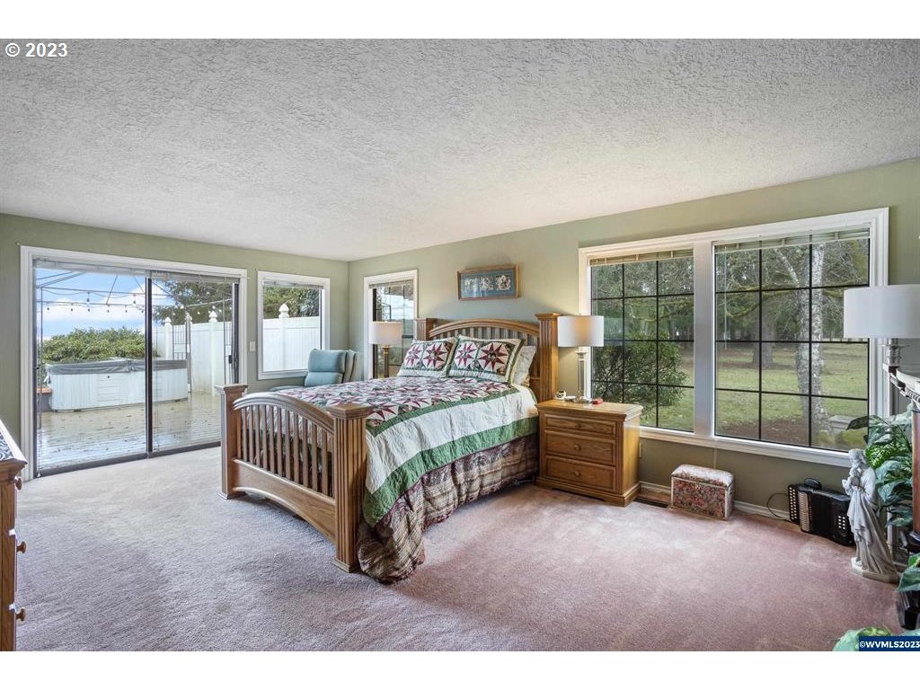 1320 North Fir Villa Road Dallas, OR 97338 - Photo 4 of 31 a spacious bedroom with a bed and a couch