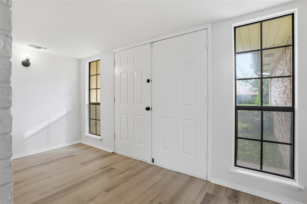 403 Redbud Drive Forney, TX 75126 - Photo 2 of 17 a view of an empty room with wooden floor and a window