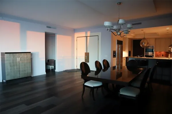 a dining room with furniture and wooden floor