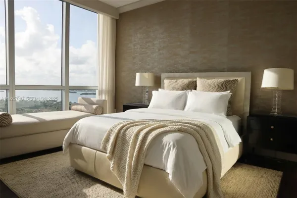 a bedroom with a large bed and a night stand