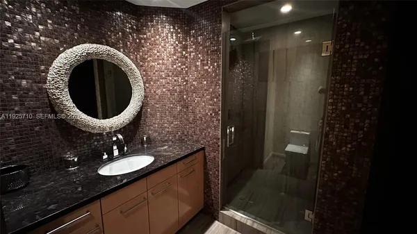 a bathroom with a sink mirror vanity and toilet