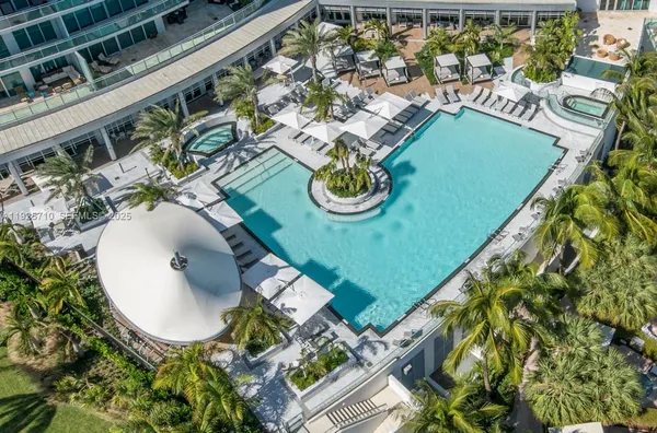 an aerial view of a house with a swimming pool