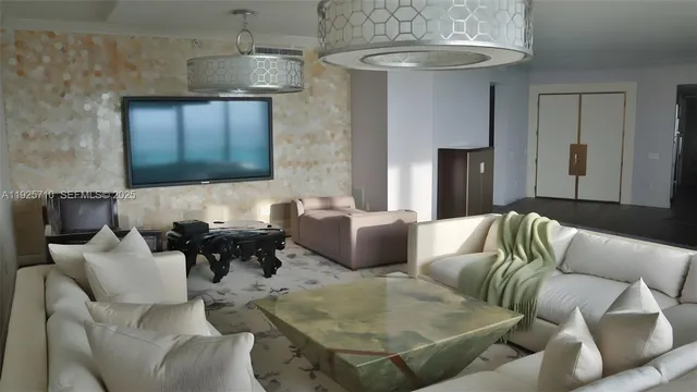 a living room with furniture and a chandelier