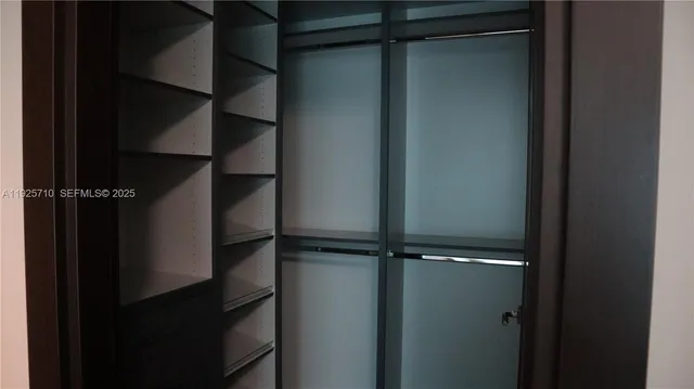 a bathroom with a double vanity sink mirror and shower