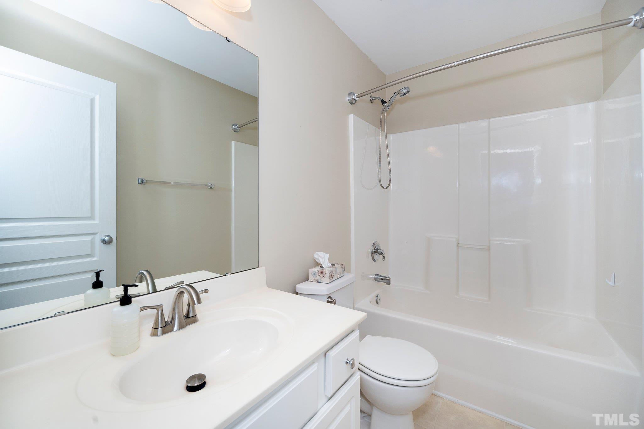 4114 Brenmar Lane Durham, NC 27713 - Photo 11 of 13 a bathroom with a sink a toilet and a mirror
