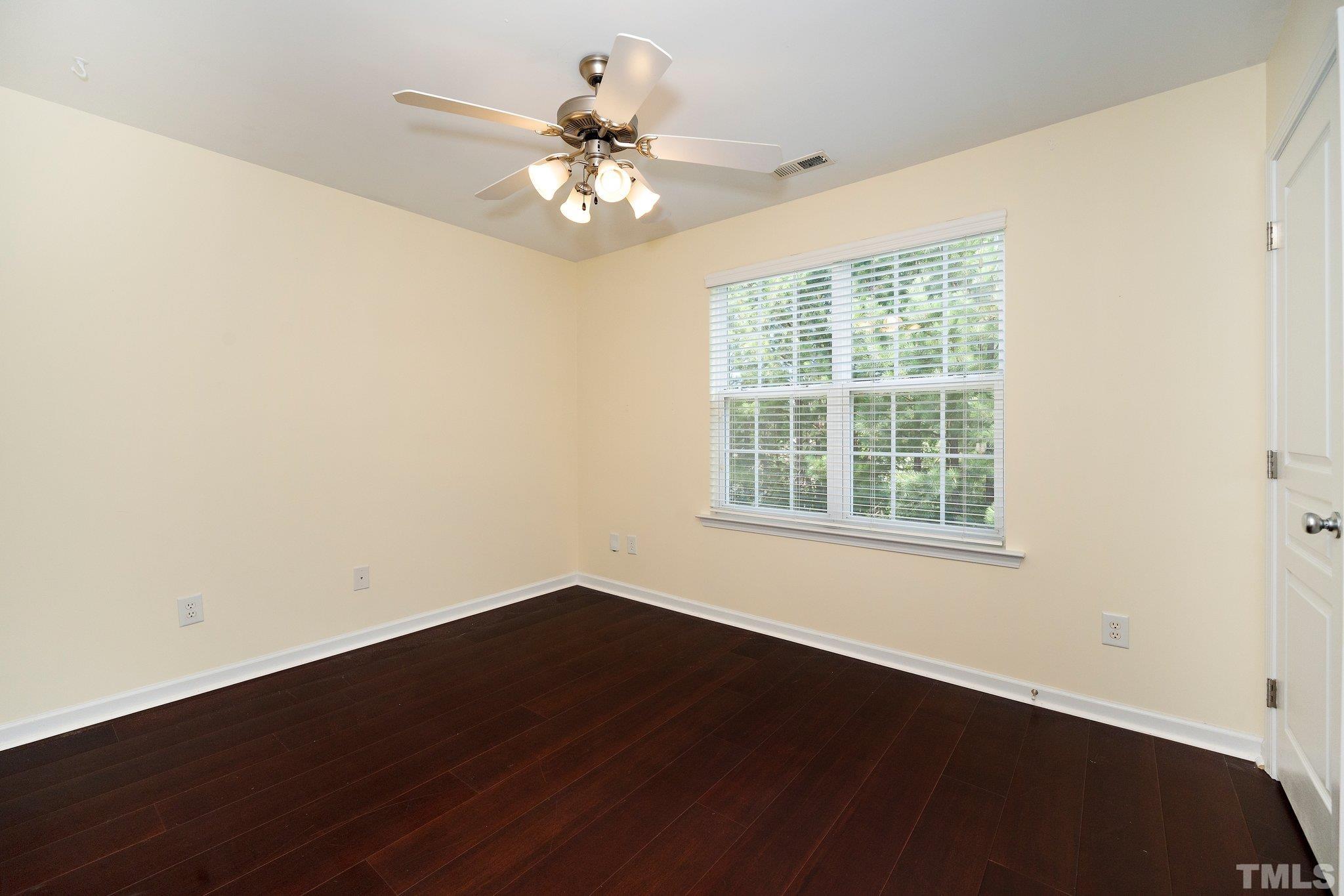 4114 Brenmar Lane Durham, NC 27713 - Photo 12 of 13 a view of an empty room with wooden floor and a window