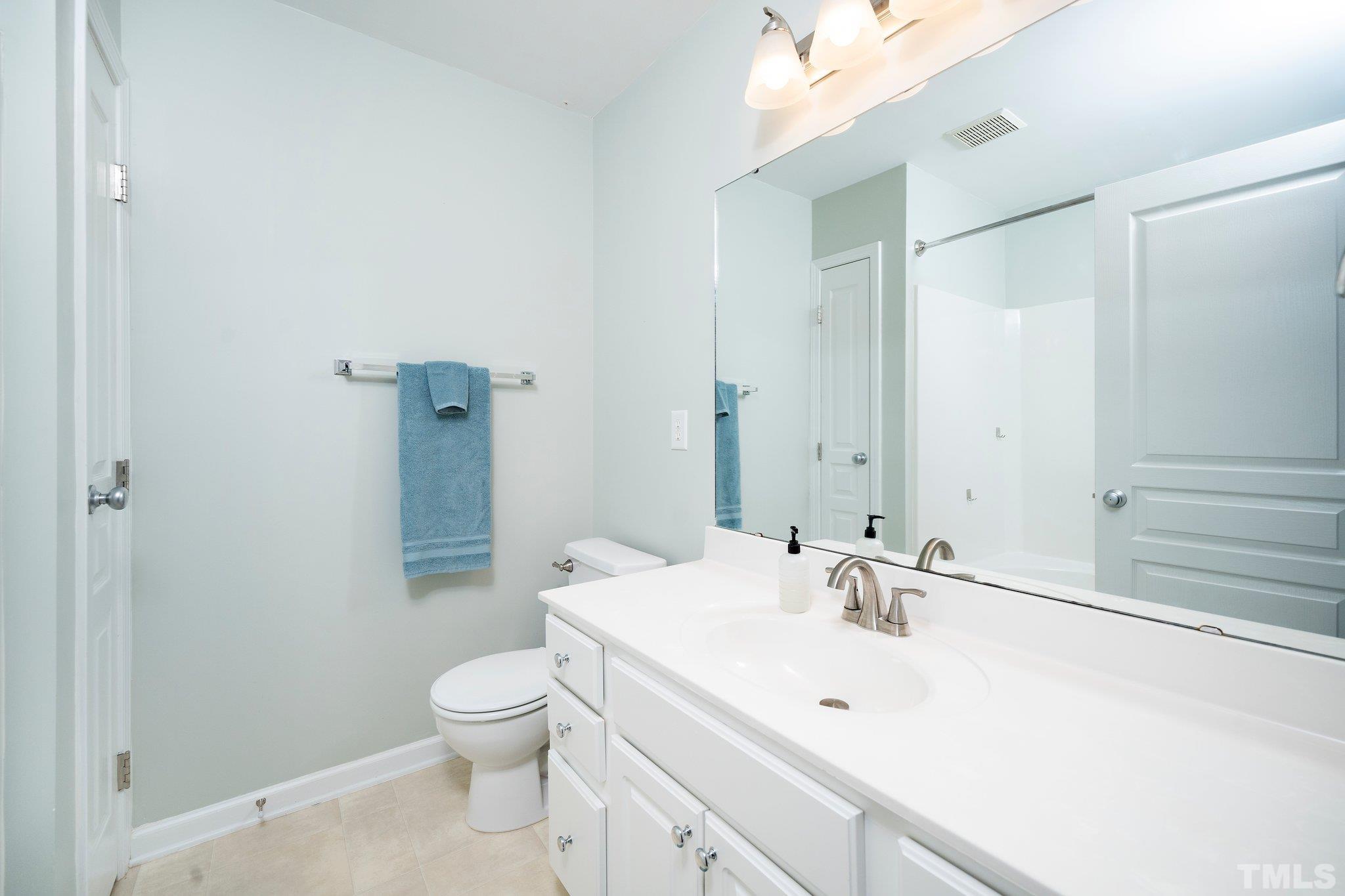 4114 Brenmar Lane Durham, NC 27713 - Photo 8 of 13 a bathroom with a sink a toilet and shower