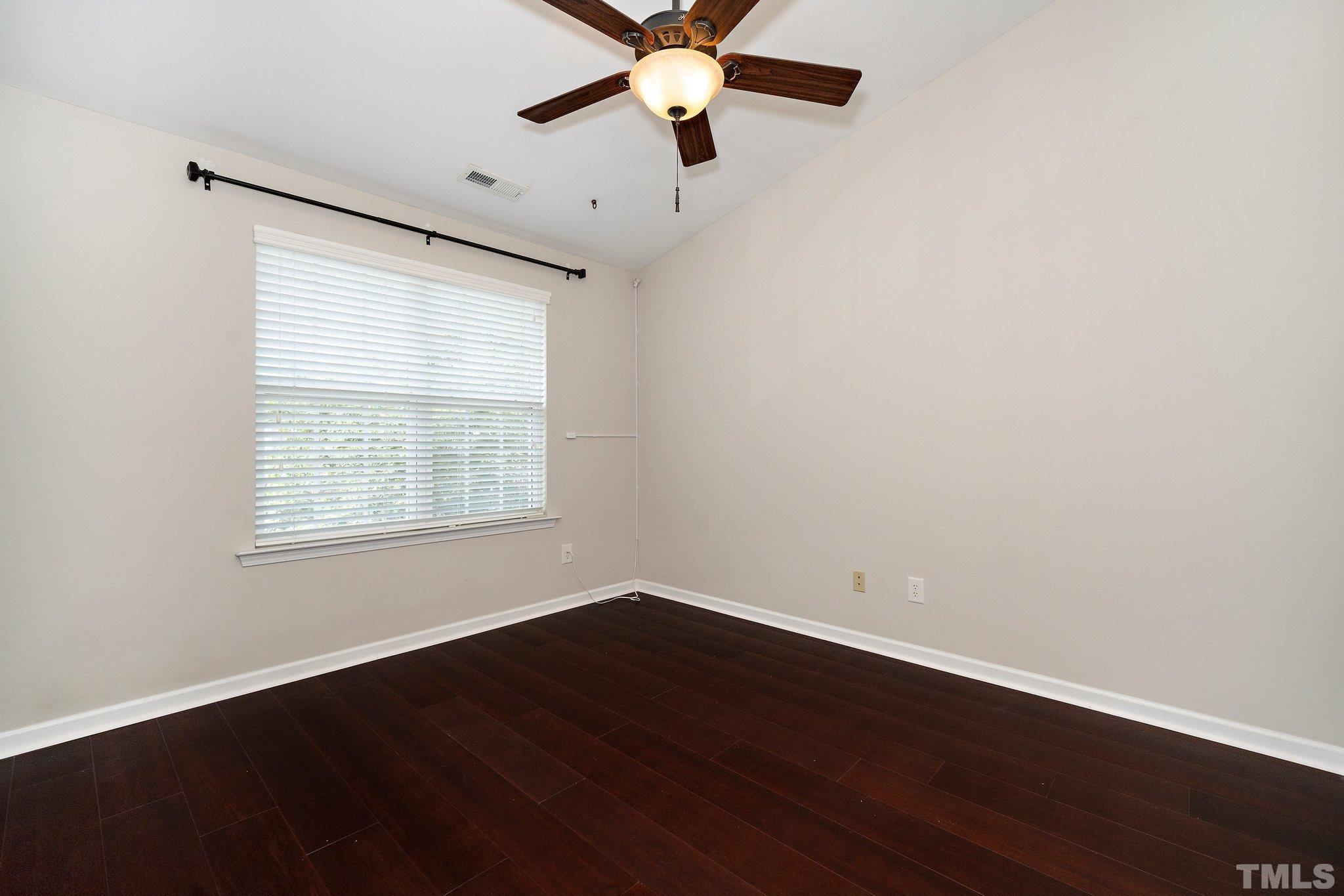 4114 Brenmar Lane Durham, NC 27713 - Photo 9 of 13 wooden floor in an empty room with a window