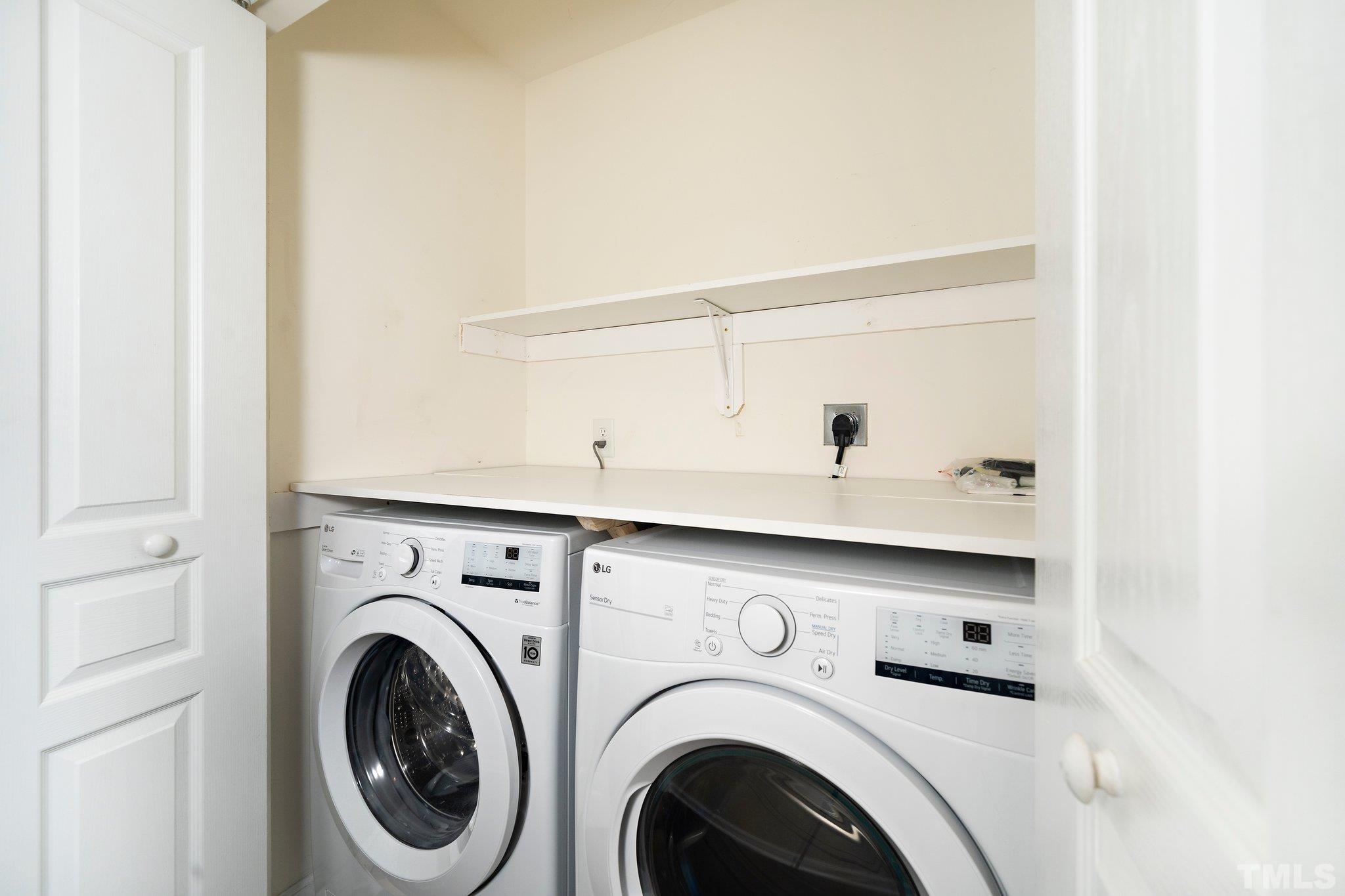 4114 Brenmar Lane Durham, NC 27713 - Photo 10 of 13 a view of washer and dryer with kitchen in the background