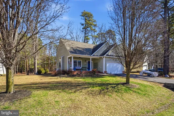 a view of a house with a yard and trees