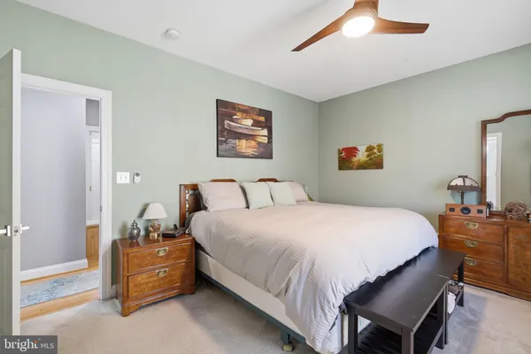 a bedroom with bed and a chandelier