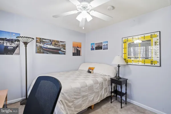 a bedroom with a bed and a desk