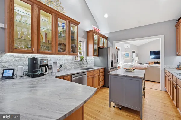 a kitchen with stainless steel appliances granite countertop a sink and cabinets