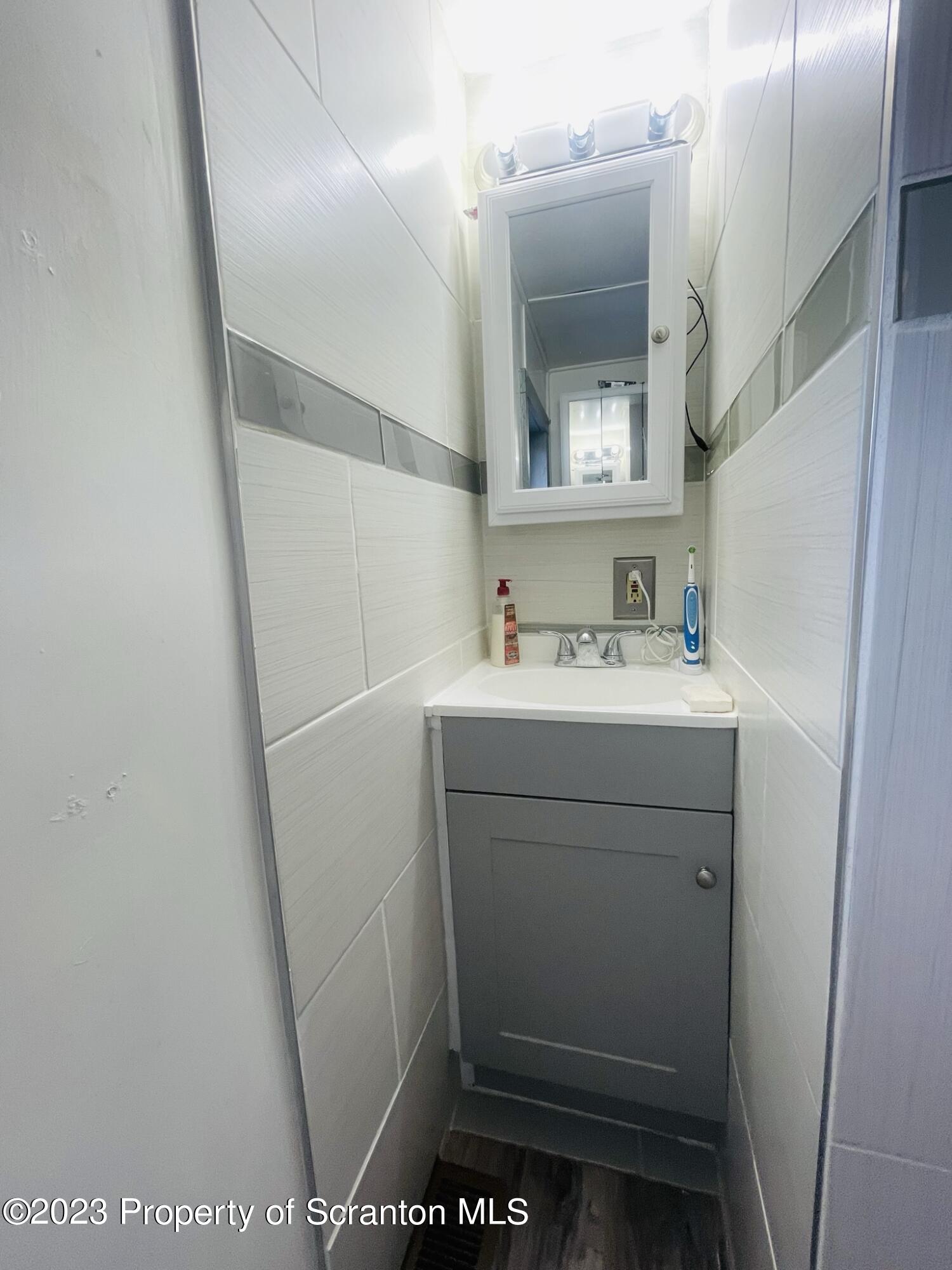 176 Stack Road Thompson, PA 18465 - Photo 13 of 53 a bathroom with a sink and a mirror