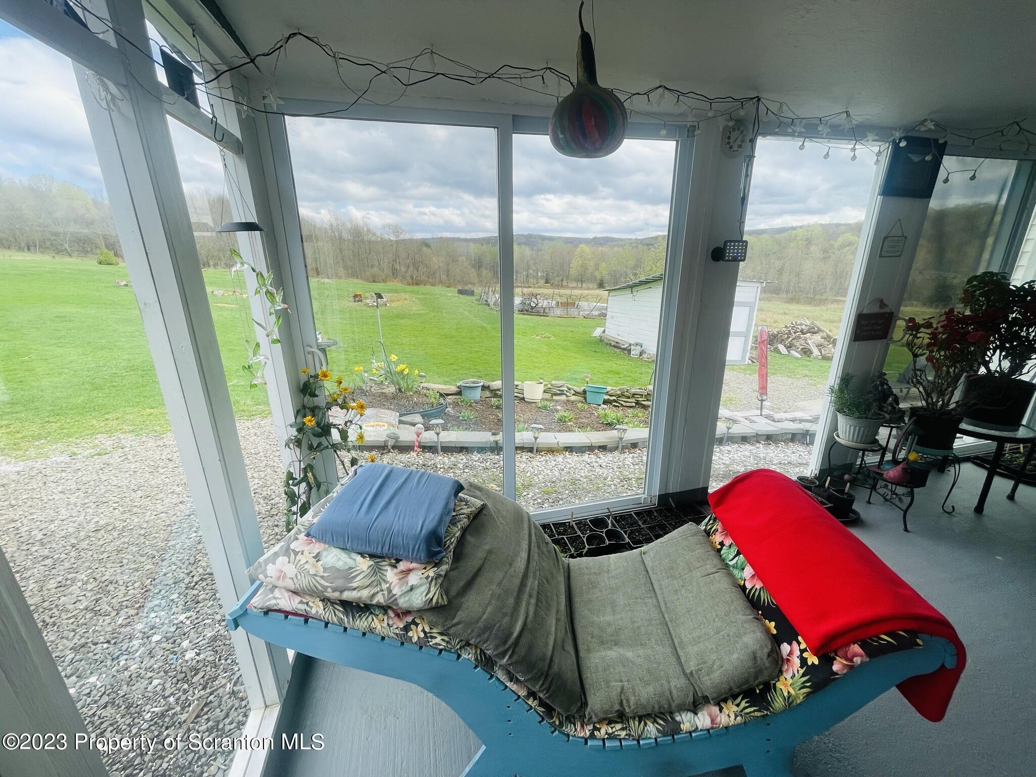 176 Stack Road Thompson, PA 18465 - Photo 17 of 53 a room with furniture and a large window