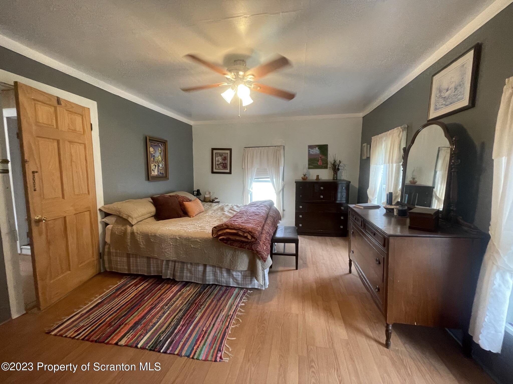 176 Stack Road Thompson, PA 18465 - Photo 18 of 53 a bedroom with furniture and a wooden floor
