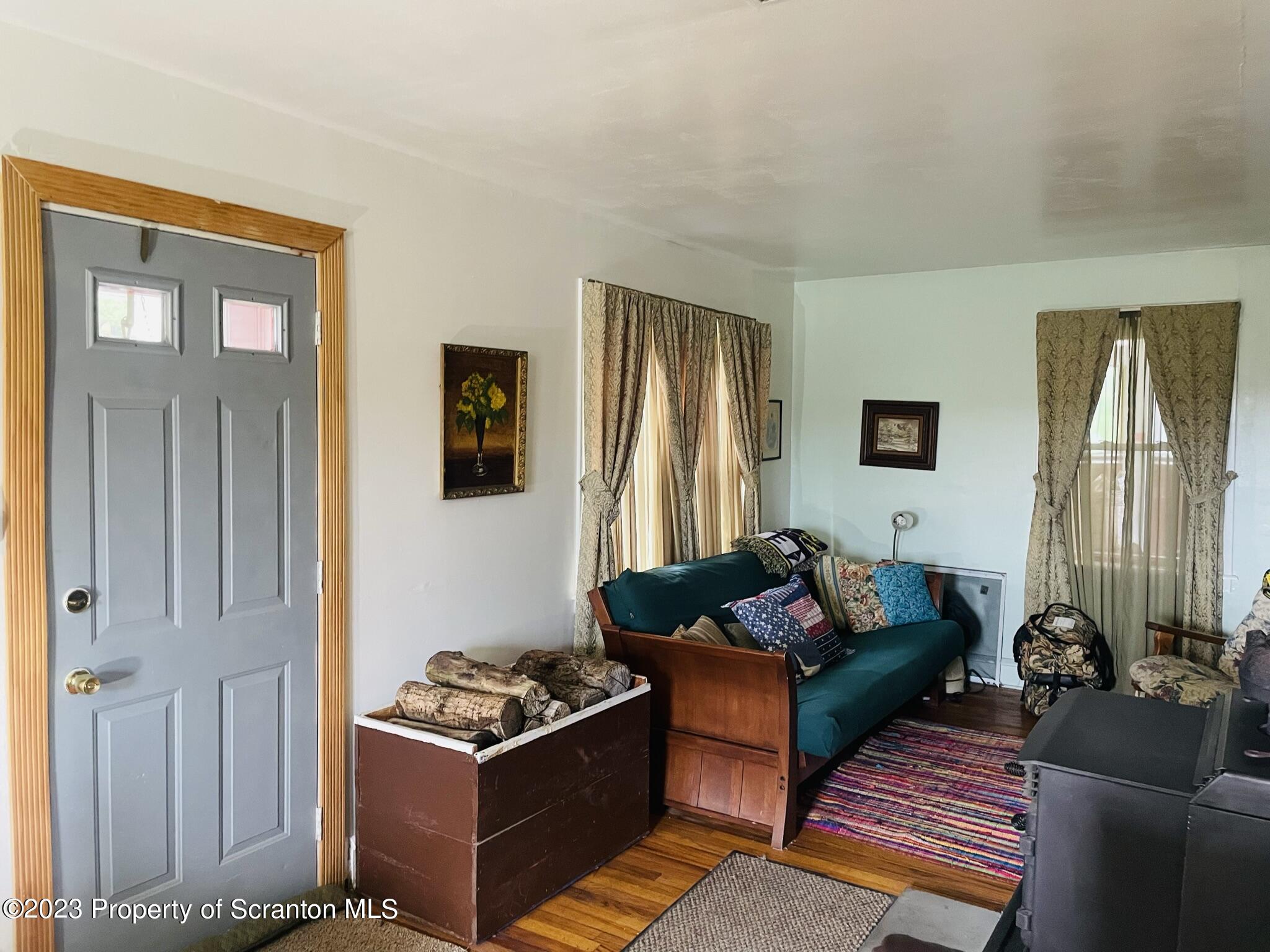 176 Stack Road Thompson, PA 18465 - Photo 2 of 53 a living room with furniture and a window
