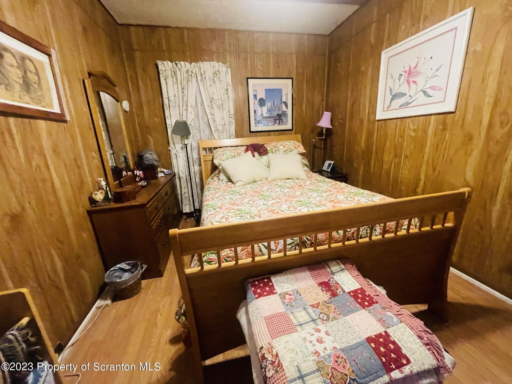 176 Stack Road Thompson, PA 18465 - Photo 22 of 53 a bedroom with a bed and a table in it